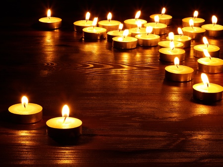 Group of burning candles on  black background.の写真素材