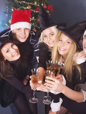 Group young people in santa hat drink champagne at nightclub.の写真素材