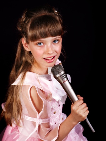Singing of little girl in microphone.の写真素材