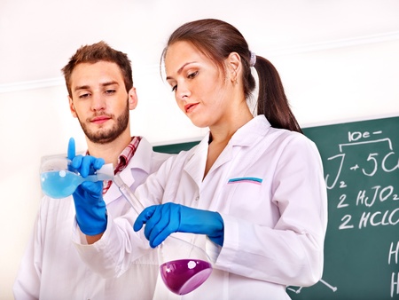 Group chemistry student with flask in classroom.の写真素材