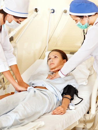Group doctor treats female patient with stethoscope. Medicine. の写真素材