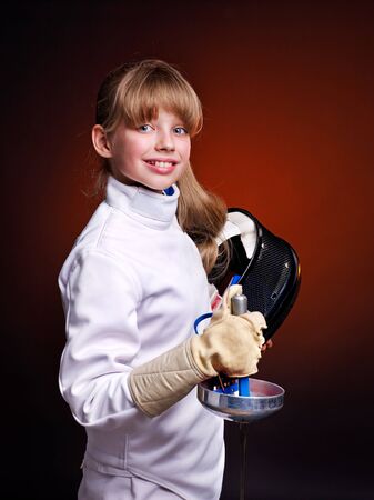 Child epee fencing lunge. Dark background.の写真素材