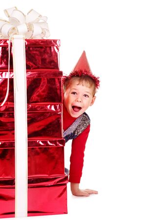 Child in party hat with stack gift box. Isolated.の写真素材