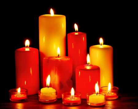 Group of burning candles on  black background.の写真素材