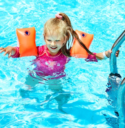 Child with armbands in swimming pool. Summer outdoor.の写真素材