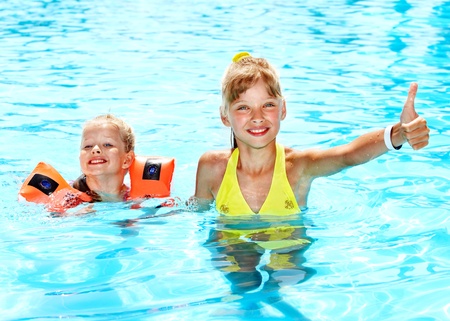 Child with armbands in swimming pool. Summer outdoor.の写真素材