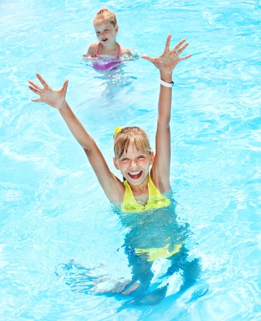 Children in swimming pool. Summer outdoor.の写真素材