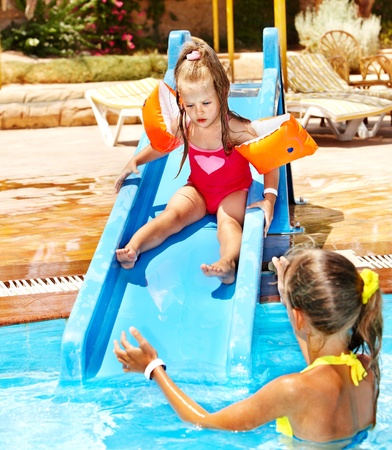 Children on water slide at aquapark. Summer holiday.の写真素材