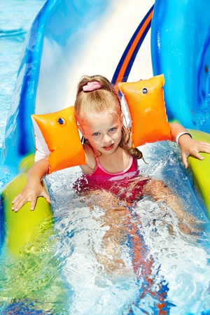 Child on water slide at aquapark. Summer holiday.の写真素材