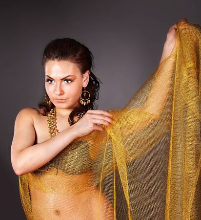 Beautiful young woman in carnival costume. on grey background.の写真素材
