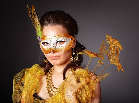 Beautiful young woman  in carnival costume with gold mask.の写真素材