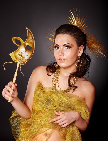 Beautiful young woman  in carnival costume with gold mask.の写真素材