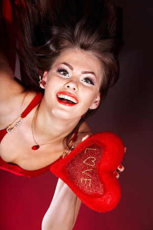 Young beautiful woman holding red heart . Valentines day.の写真素材