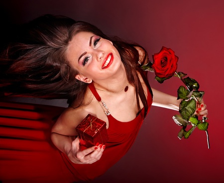 Young woman with flower and gift box. Valentine's day.の写真素材
