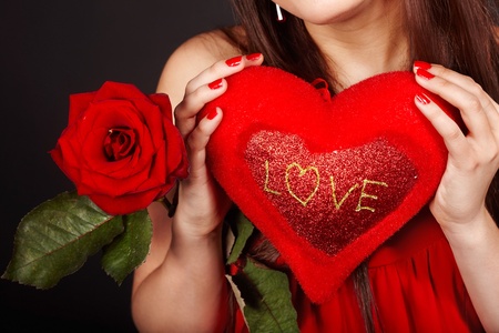 Girl with  heart and flower rose on red  background.  Valentines day.の写真素材