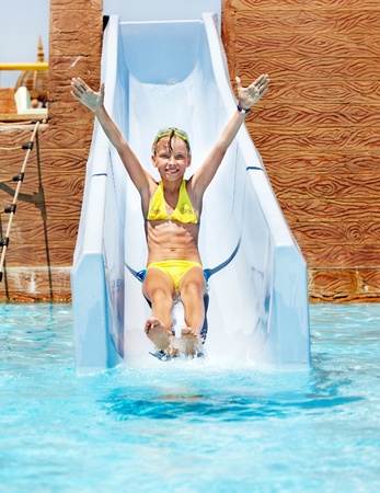 Child on water slide at aquapark. Summer holiday.の写真素材