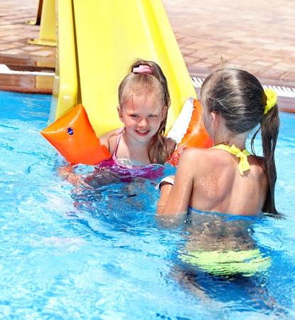Children on water slide at aquapark. Summer holiday.の写真素材