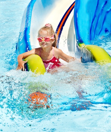 Child on water slide at aquapark. Summer holiday.の写真素材
