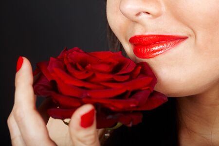 Girl with rose on red background. Valentines day.の写真素材