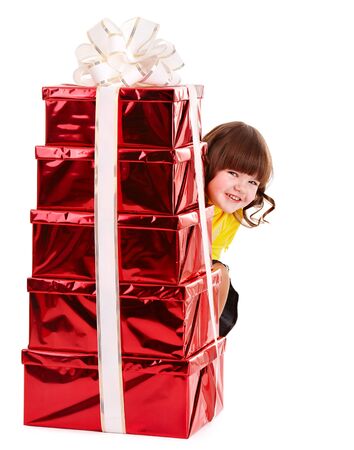 Child in Santa hat with stack gift box. Isolated.の写真素材