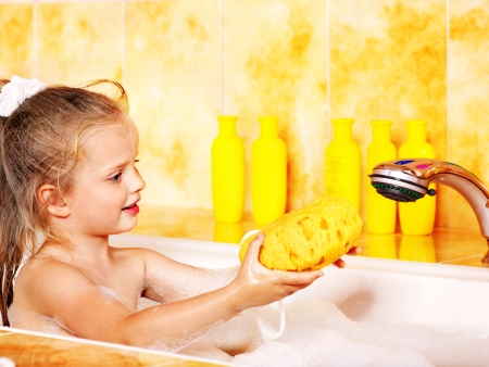Child washing in bubble bath .の写真素材