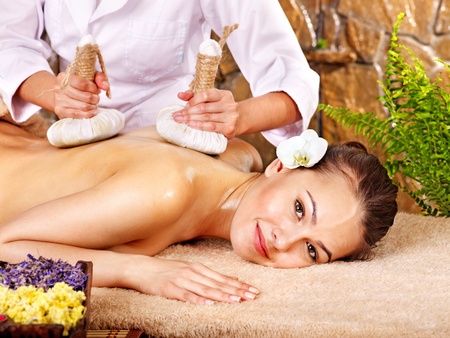 Young woman getting massage in bamboo spa.の写真素材
