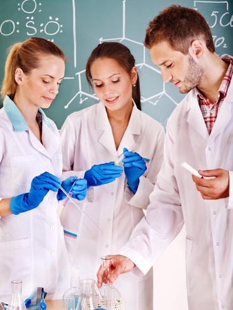 Group chemistry student with flask in classroom.の写真素材