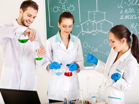 Group chemistry student with flask in classroom.の写真素材