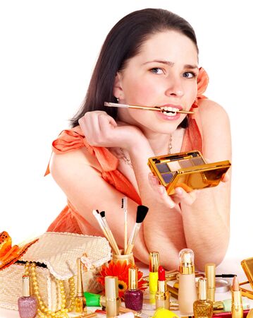 Girl applying makeup. Isolated.の写真素材
