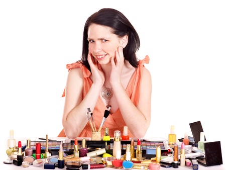 Girl applying makeup. Isolated.の写真素材