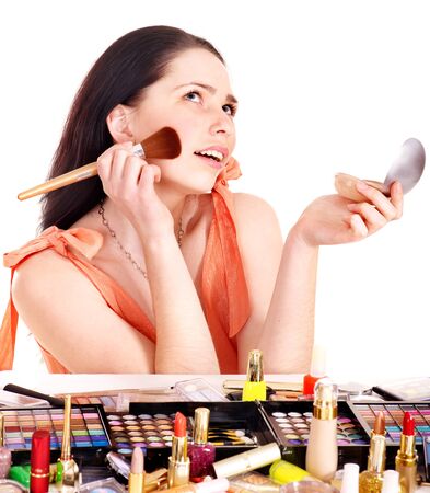 Girl applying makeup. Isolated.の写真素材