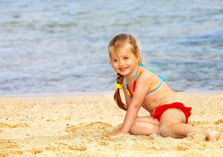 Little girl  playing on  beach.の写真素材