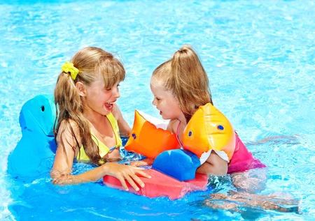 Child with armbands in swimming pool.の写真素材
