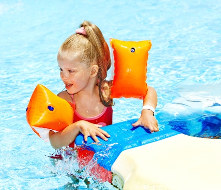 Child with armbands in swimming pool. Summer outdoor.の写真素材