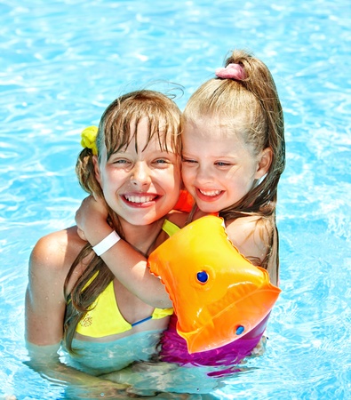 Children with armbands in swimming pool.の写真素材