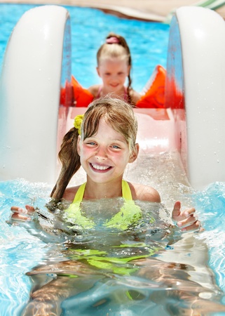 Children on water slide at aquapark. Summer holiday.の写真素材
