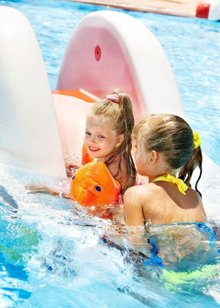 Children on water slide at aquapark. Summer holiday.の写真素材