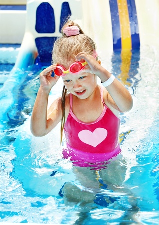 Child on water slide at aquapark. Summer holiday.の写真素材