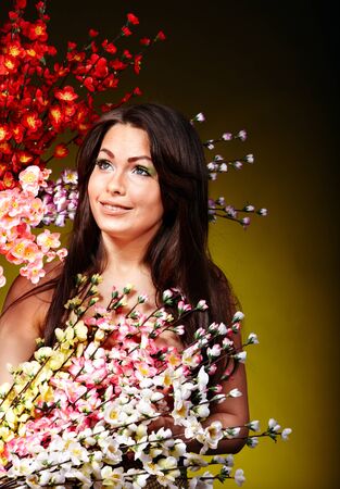 Young woman holding spring flower.の写真素材