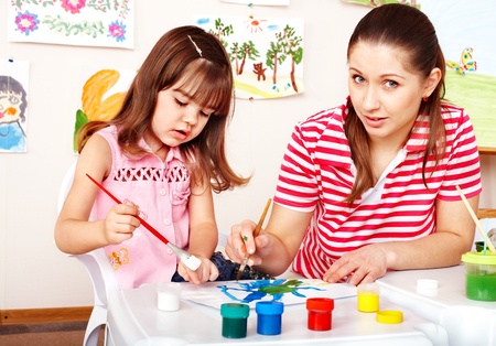 Little girl painting with mother  in preschooler.の写真素材
