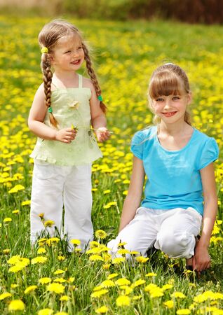 Children in field with flower. Outdoor.の写真素材