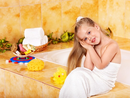 Little girl washing in bubble bath .の写真素材