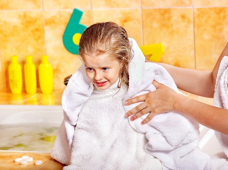 Little girl washing in bubble bath .の写真素材