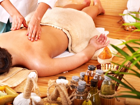 Young woman getting massage in bamboo spa.の写真素材