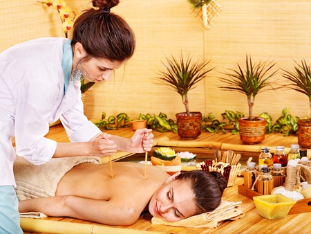 Young woman getting bamboo massage.の写真素材