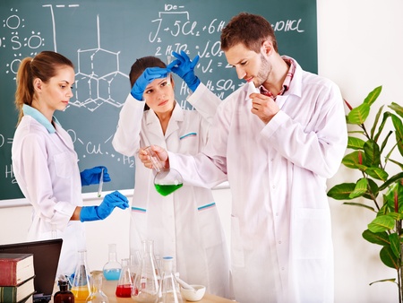 Group chemistry student with flask in classroom.の写真素材