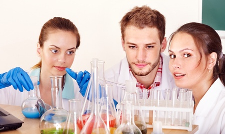 Group chemistry student with flask in classroom.の写真素材