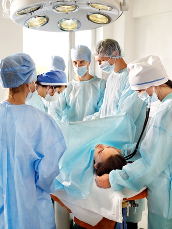 Sick patient on gurney in operating room.の写真素材