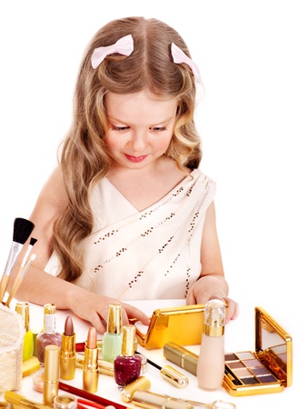Child cosmetics. Little girl applying make up. Isolated.の写真素材