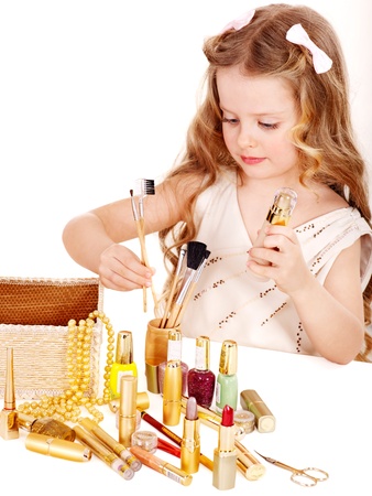  Little girl applying make up. Isolated.の写真素材